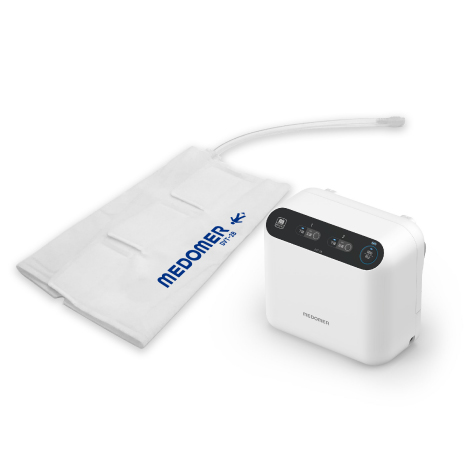 日東工器「DVT-2B」間欠的空気圧迫装置のプロダクトデザイン実績。マットホワイトの本体、視認性に優れた上部の操作パネル、脚部カフと透明チューブ。現場の課題解決から生まれた、確実な施療と高いメンテナンス性を備えた医療機器の外観